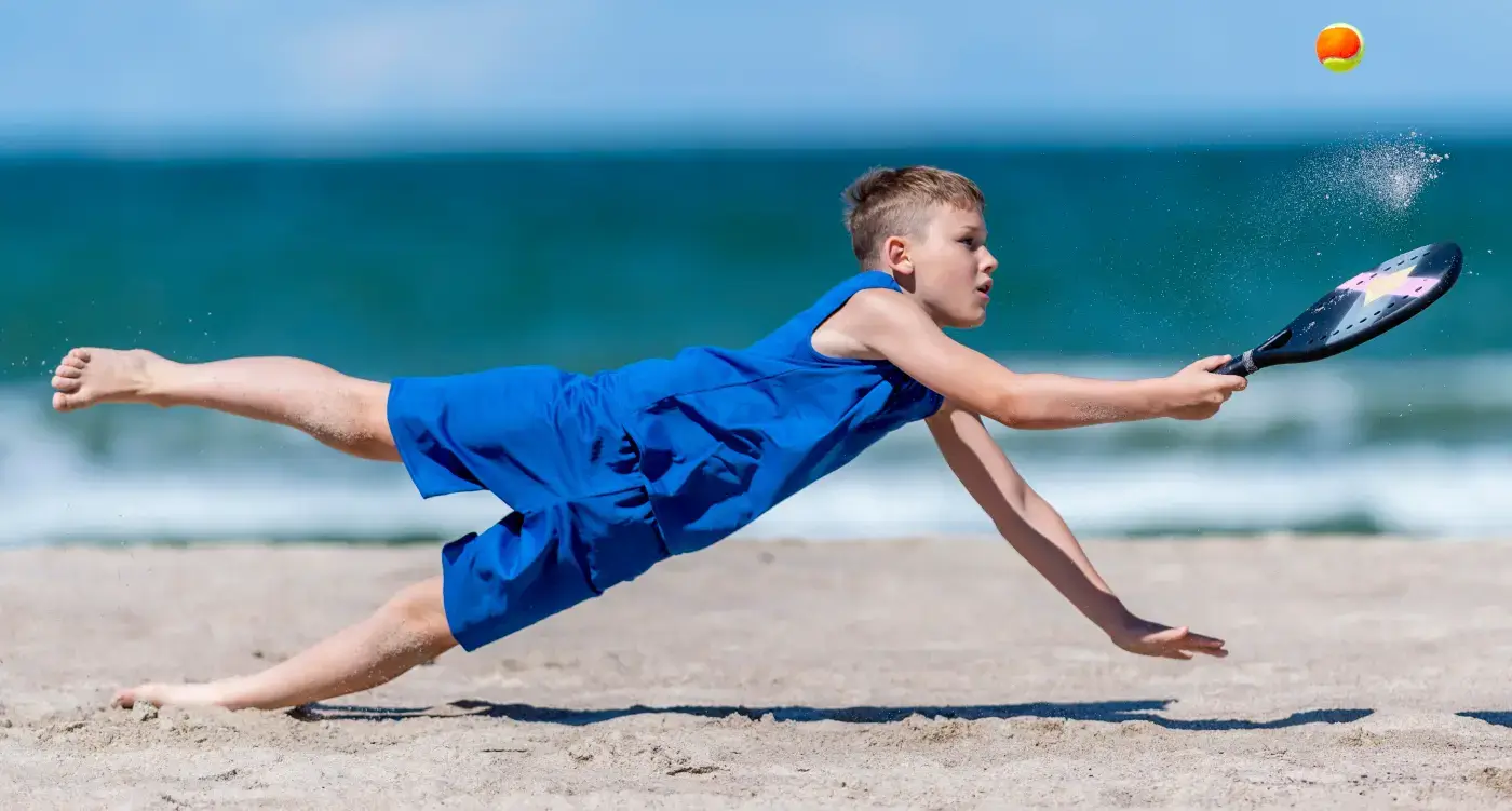 8-fun-third Kid Playing Badminton on the Beach