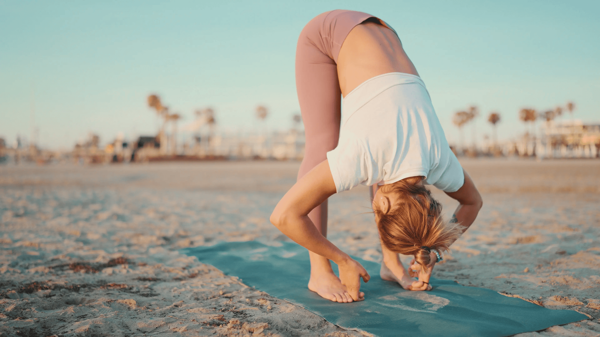 beach-yoga-meditation-health Woman on the Beach Sand Doing Yoga